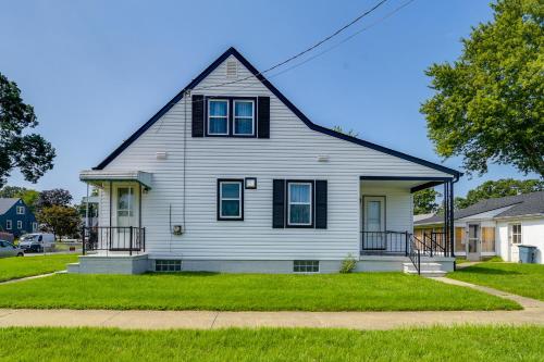 a white house with a gambrel roof at 13 Mi to Downtown Baltimore Quiet Home with Porch in Middle River