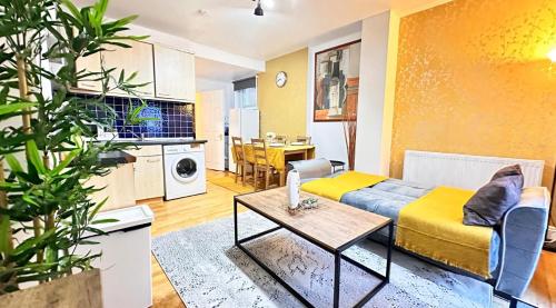 a living room with a couch and a table at Entire Flat in FINCHLEY ROAD in London