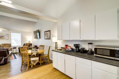 a kitchen with white cabinets and a dining room at Wine Tours and Antiquing Townhome Near Dtwn Brenham in Brenham