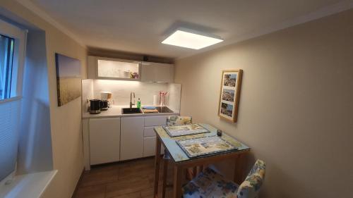 a small kitchen with a table and a counter at Ferienwohnung Stein in Sassnitz