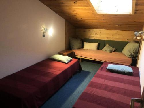 a small room with two beds and a window at Résidence Marches - Les Marches 24 - Joli 2 pièces en bordure de pistes MAE-5034 in Valmorel