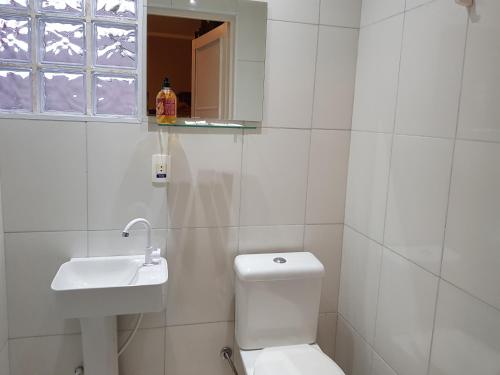 a white bathroom with a toilet and a sink at Pousada Mirante da Serra Fonte Sônia-Valinhos in Valinhos
