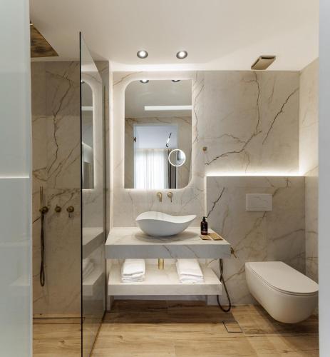 a bathroom with a sink and a toilet at GkF Luxury Villas in Naxos Chora
