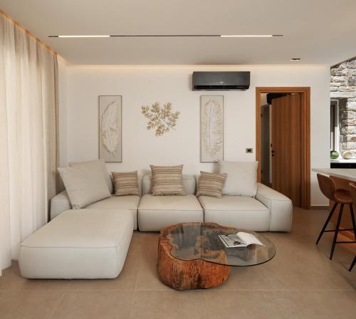 a living room with a white couch and a coffee table at GkF Luxury Villas in Naxos Chora