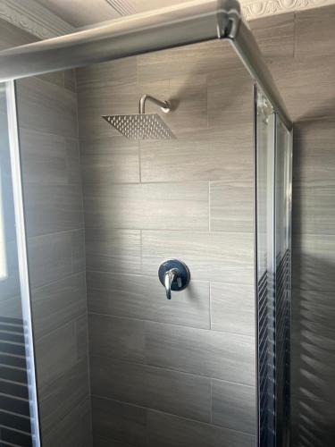 a shower with a shower head in a bathroom at Inala Urban Guesthouse in Bulawayo