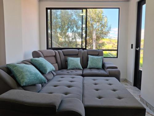 a living room with a couch and a large window at Lindo apartamento en Villapinzon in Villapinzón