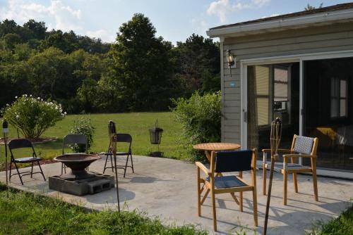 a group of chairs and a table on a patio at Luxurious 3 Bedroom, 3 Bathroom, Entire Home in Catskill in Catskill