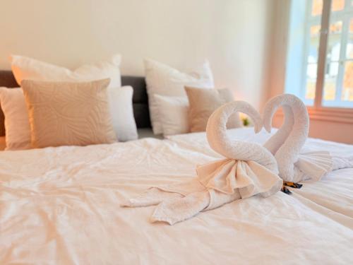 two white swans sitting on top of a bed at DREAMZzz l Perfekt für Familien & Paare l Innenstadt Coburg l Parkhaus 100 Meter in Coburg