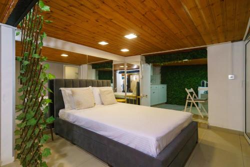 a bedroom with a bed with a wooden ceiling at City Centre Studio Eleftheria Sq in Nicosia