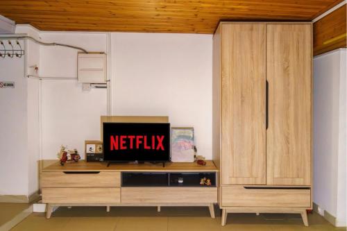 a tv on a wooden cabinet in a living room at City Centre Studio Eleftheria Sq in Nicosia