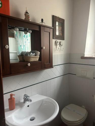a bathroom with a sink and a toilet at Casa vacanze San Rocco in San Venanzo