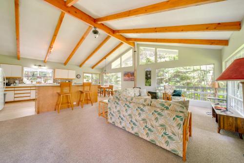 a living room with a couch and a kitchen at Private Hot Tub and Deck Tranquil Volcano Hideaway! in Volcano
