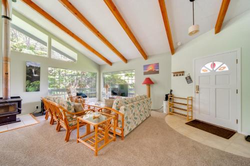 a living room with a couch and a table at Private Hot Tub and Deck Tranquil Volcano Hideaway! in Volcano