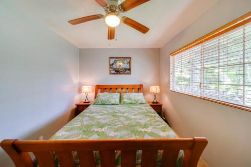 a bedroom with a bed and a ceiling fan at Private Hot Tub and Deck Tranquil Volcano Hideaway! in Volcano