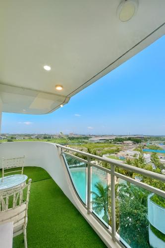 a balcony with a view of the ocean at NAMI Suite Japandi-Inspired 1BR at Azure North in San Fernando