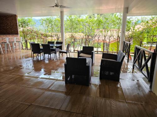 a dining room with chairs and a table with a view at La Casa de la Montaña in El Picacho