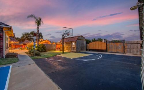 an empty basketball court with a basketball hoop at Tropical Escape Pool Jacuzzi Bar in Alvin TX in Alvin