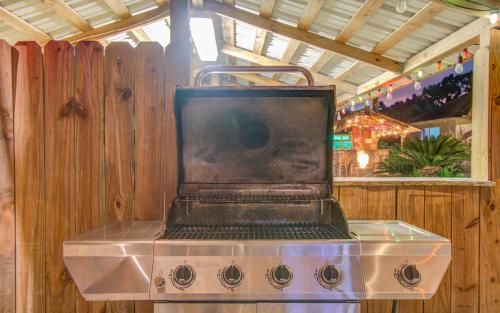 a stove with a laptop sitting on top of it at Tropical Escape Pool Jacuzzi Bar in Alvin TX in Alvin