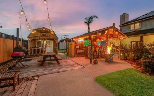 a backyard with a wooden deck with a gazebo at Tropical Escape Pool Jacuzzi Bar in Alvin TX in Alvin