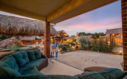 a living room with a couch and a patio at Tropical Escape Pool Jacuzzi Bar in Alvin TX in Alvin