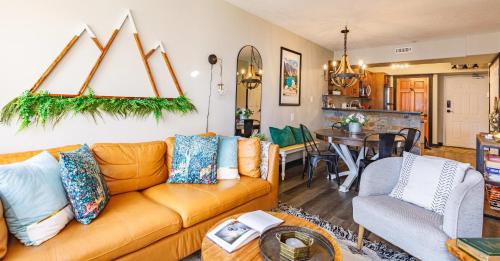 a living room with a couch and a dining room at Alpine Oasis at Alpine Village in Canmore