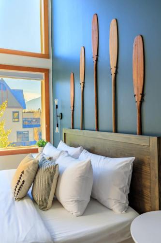 a bed with a bunch of pillows on it at Alpine Oasis at Alpine Village in Canmore
