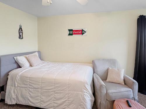 a bedroom with a bed and a chair at Blue bird House- 6 Rooms for extended room stay in Brownfield