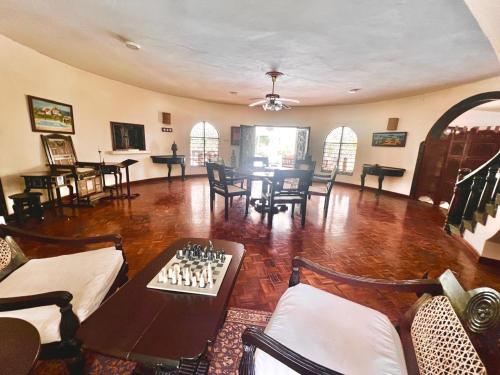a living room with a chess board on a table at Paradise Garden watamu in Watamu