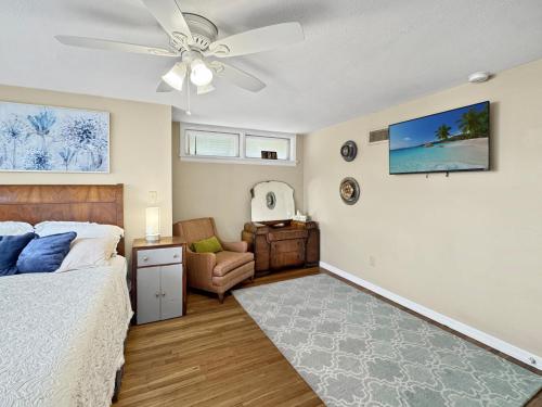 a bedroom with a bed and a ceiling fan at Blue bird House- 6 Rooms for extended room stay in Brownfield