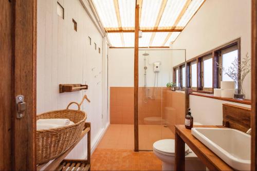 a bathroom with a sink and a toilet and a shower at Mana Craft Stay in Bangkok