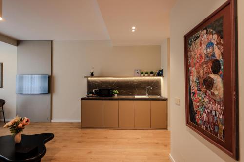 a kitchen with a large painting on the wall at Giselle Escape in Tirana