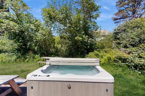 a hot tub in the middle of a yard at Once Upon a Tide in Lincoln City