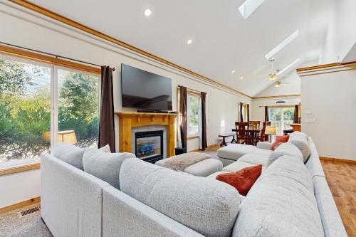 a living room with two white couches and a fireplace at Once Upon a Tide in Lincoln City