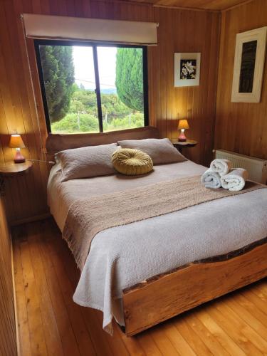 a bedroom with a large bed with a large window at Hostal Boutique El Vergel Azul in Castro