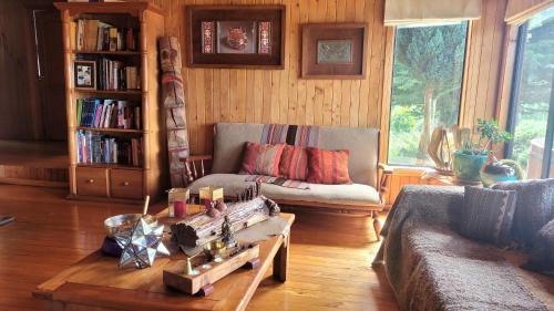 a living room with a couch and a coffee table at Hostal Boutique El Vergel Azul in Castro