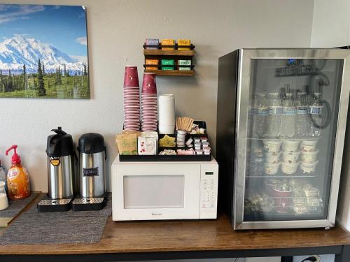 a microwave sitting on a counter next to a refrigerator at Golden North Inn in Fairbanks