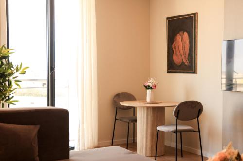 a living room with a table and two chairs at Giselle Escape in Tirana