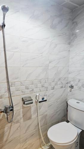 a bathroom with a toilet and a shower at Luluat Al Badaie Hotel in Makkah