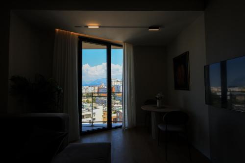 a room with a window with a view of a city at Giselle Escape in Tirana