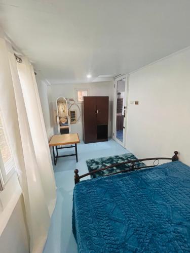 a bedroom with a bed and a chair in it at Barracuda Swim Club's Homestay - Aircon Room with Pool in Coron