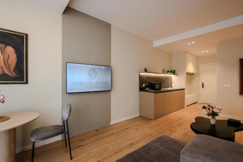 a living room with a television on a wall at Giselle Escape in Tirana