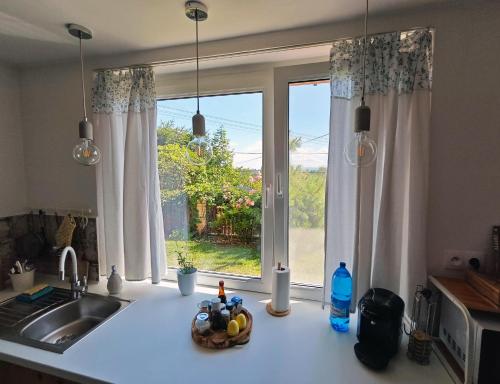 a kitchen counter with a sink and a window at Penzión Tatroom in Poprad