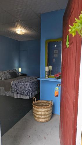 a bedroom with a bed and a basket next to a door at Sweet Dreams in San Carlos