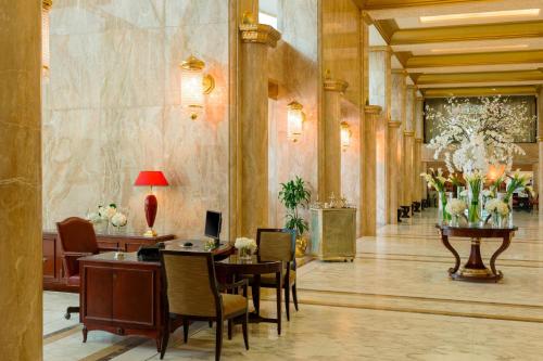 a lobby with chairs and tables in a building at Sheraton Kuwait, a Luxury Collection Hotel, Kuwait City in Kuwait