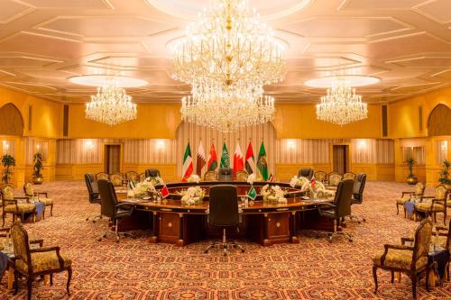 a large meeting room with a large table with flags at Sheraton Kuwait, a Luxury Collection Hotel, Kuwait City in Kuwait