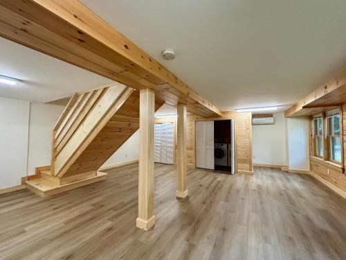 an empty room with wooden stairs in a house at Casco Cabin Freeport in Freeport