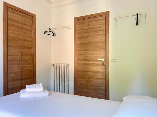 a bedroom with a bed and a wooden door at New Residence Emilia in San Donato Milanese