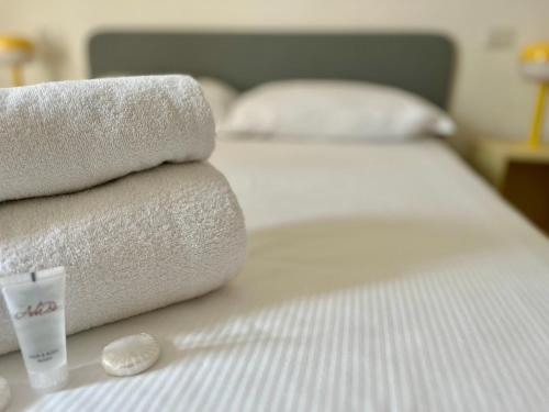 a bed with towels and a cup on top of it at New Residence Emilia in San Donato Milanese