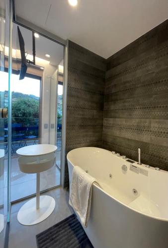 a large bathroom with a tub and a sink at SeaNest Bali in Bali