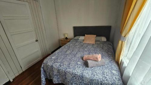 a bedroom with a bed with two towels on it at Hostal Gloria Viña 2 poniente 333 in Viña del Mar